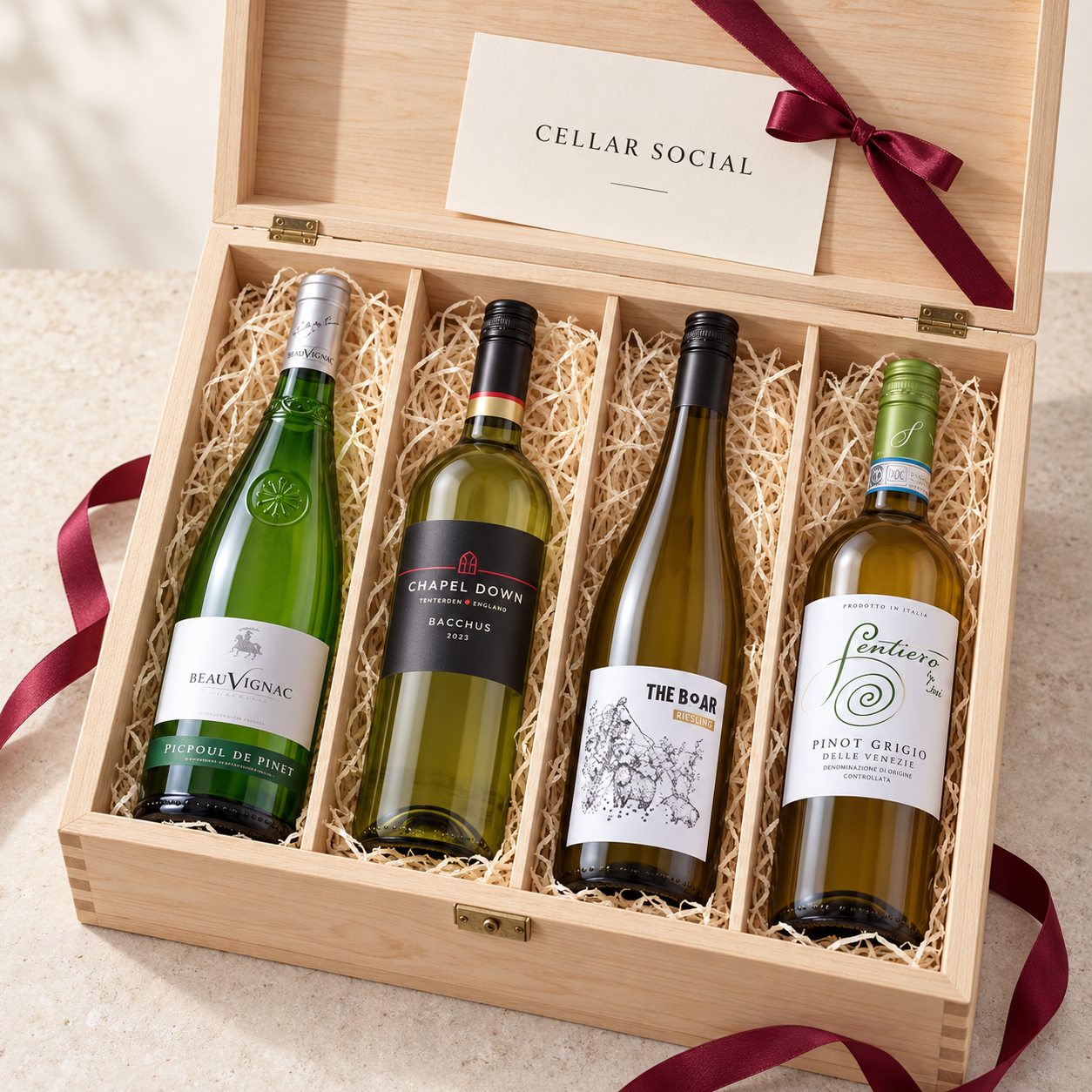 Four white wines in a wooden Cellar Social hamper